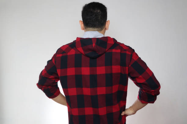 istock Rear view of a man facing grey copy space background, men's back, thinking gesture 1283586237