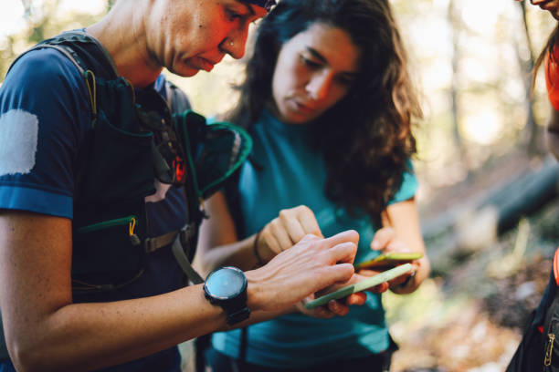 istock Women on a hike checking their smartphones 1283587056