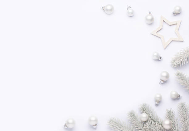 istock Light composition with white Christmas balls and spruce branches. 1283593025