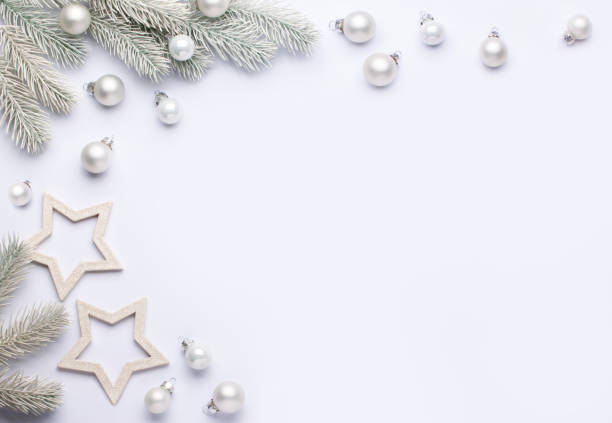 istock Light composition with white Christmas balls and spruce branches. 1283593030