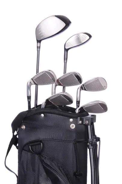 Set of golf clubs in a black bag on a white background.