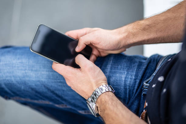 istock Businessman hand holding cell phone 1283598842