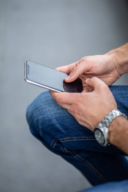 istock Businessman hand holding cell phone 1283598885