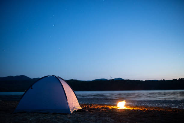 istock An illuminated tent at night in the mountain and camp fire 1283599829