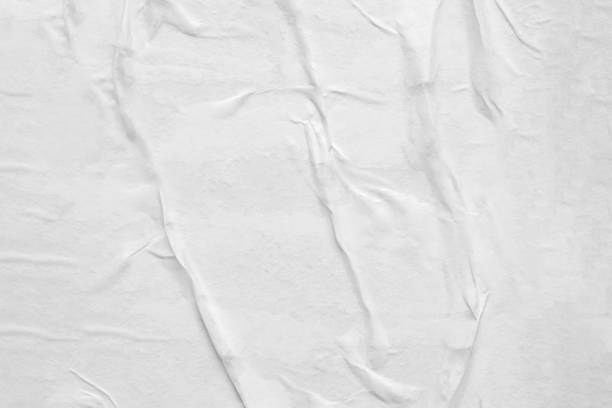 istock Blank white crumpled and creased paper poster texture background 1283599940