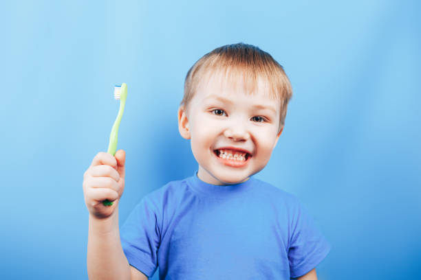 istock smile boy cleans a teeth with toothbrush 1283601347