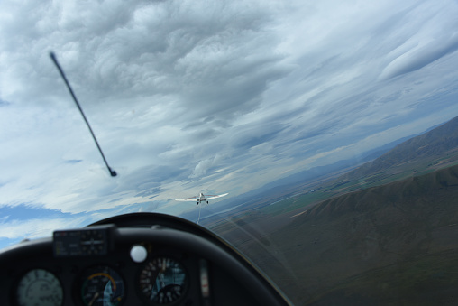 A full frame panoramic view from inside a sailplane capturing the towplane in front, prior to release over Omarama on the South island of New Zealand. Of course there is window glare, motion blur, and the horizon is tilted.