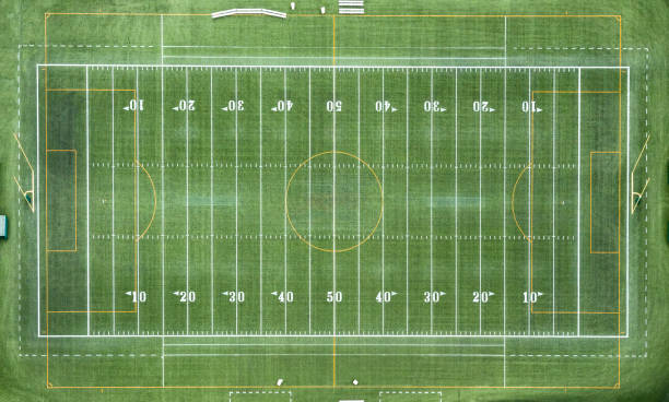 American Football Field Aerial An aerial view of a full 100 yard long, marked football field shot from directly overhead from an altitude of about 1000 feet. american football field photos stock pictures, royalty-free photos & images