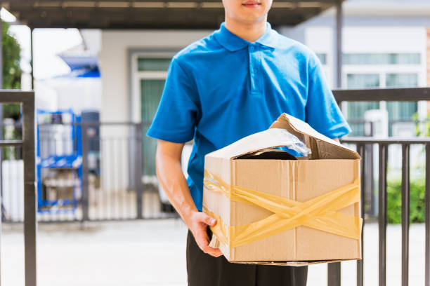 istock Delivery man he emotional courier hold damaged cardboard box is broken 1283602330