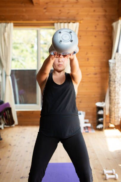 istock A woman exercising at home with a kettlebell 1283603935