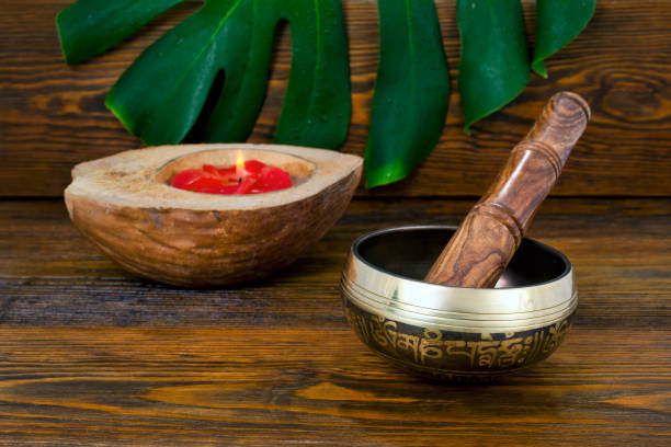 istock Tibetan singing bowl with monstera leaf and coconut candle 1283604578