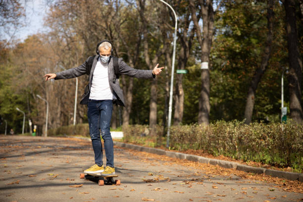 istock Happy man enjoying skateboarding outdoors during pandemic 1283604680