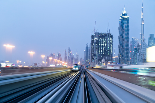 Dubai skyline with motion blurred railroad tracks, long exposure.