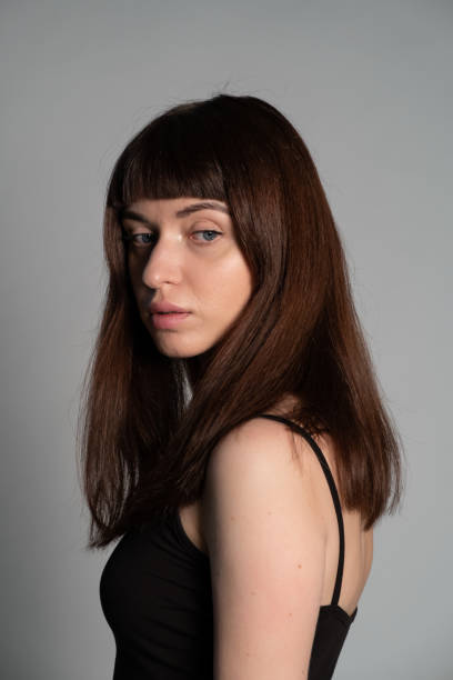istock Studio portrait of a young woman against plain grey background 1283605397