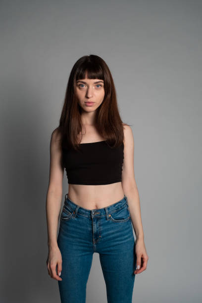 istock Studio portrait of a young woman against plain grey background 1283605398