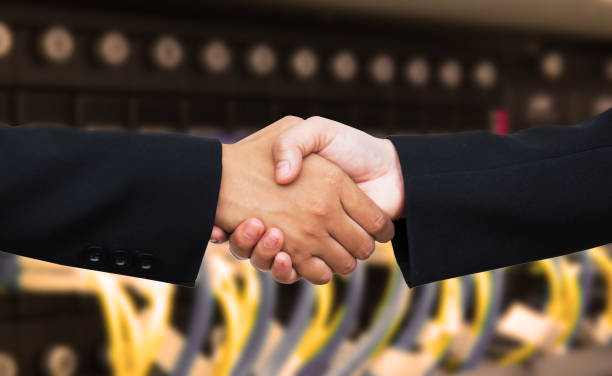 istock Hand shake on cyan sky clouds background cooperation concept. 1283605399