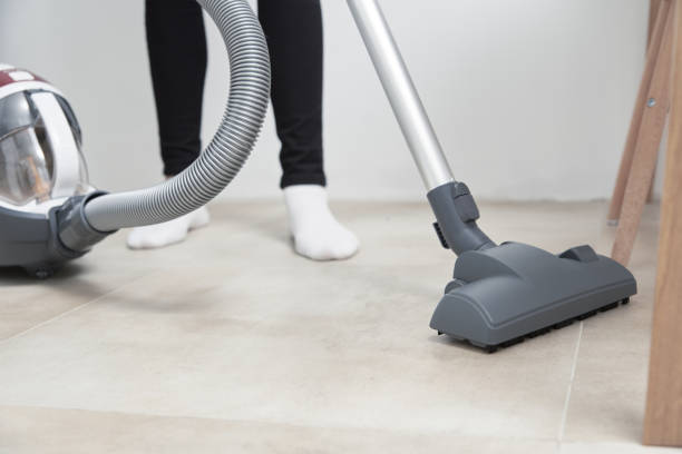 istock Woman use vacuum cleaner at the floor 1283606130