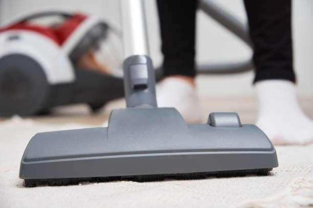 istock Woman use vacuum cleaner at the floor 1283606132
