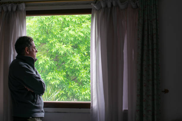 istock adult man looking out window 1283607873
