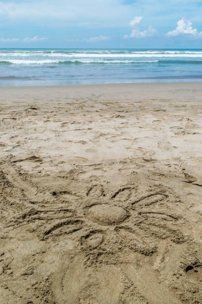 istock Sun painted on sand in the ocean 1283615190