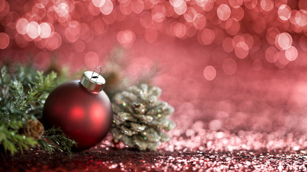 istock Christmas Red Bauble on a Red Defocused Lights Background 1283615896