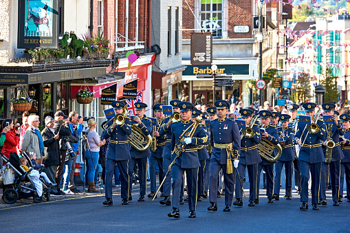 Windsor, UK - November 2, 2020: Military band playing and walking at street near Windsor Castle. This is the famous tourist attraction in Berkshire, UK.