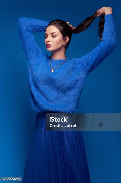 Studio Fashion Lovely Young Woman Dressed In Blue Skirt And Sweater Portrait Of Beautiful Girl Stock Photo - Download Image Now