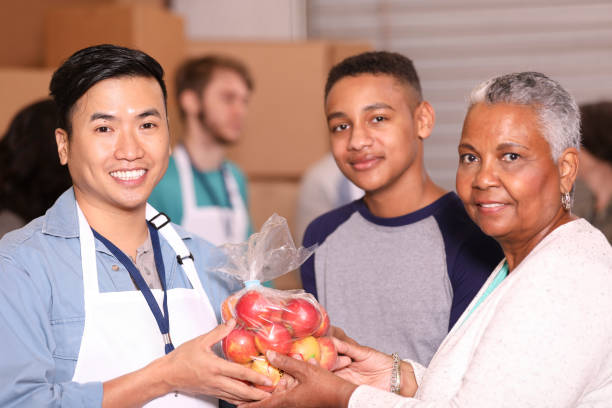istock Multi-ethnic group of volunteers work at food bank. 1283625559