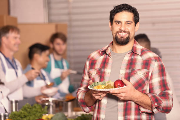 istock Multi-ethnic group of volunteers work at soup kitchen. 1283626127