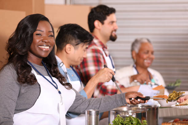 istock Multi-ethnic group of volunteers work at soup kitchen. 1283626314