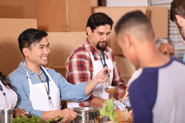 istock Multi-ethnic group of volunteers work at soup kitchen. 1283626576