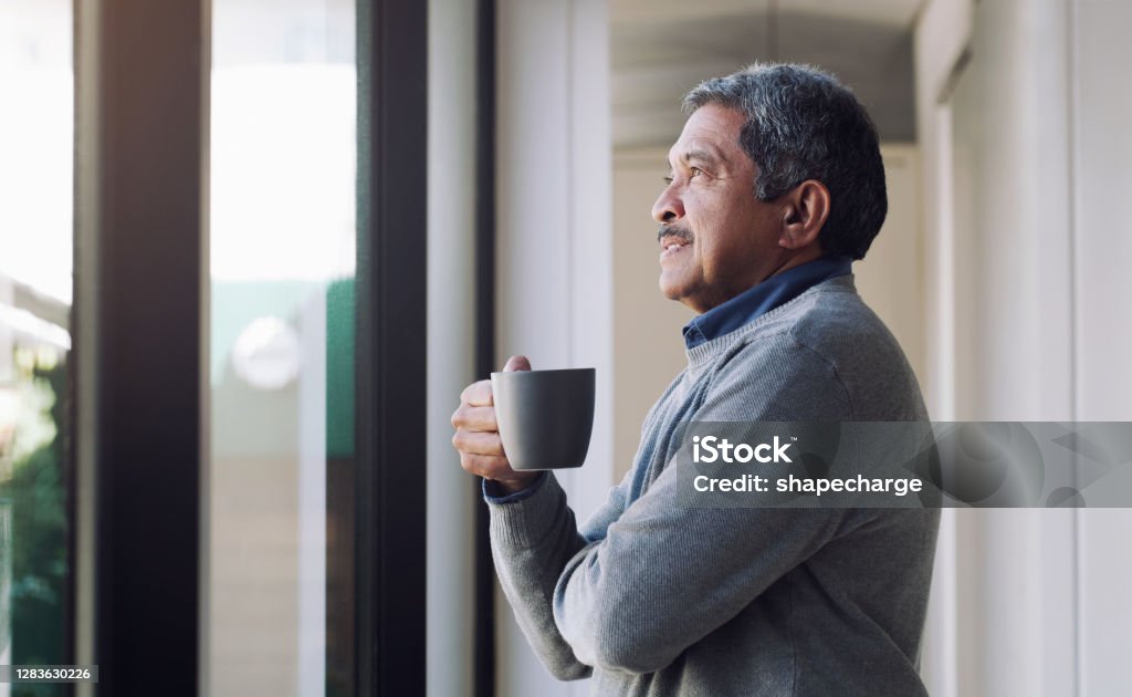 Relax, you did good Shot of a senior man drinking coffee and looking thoughtfully out of a window Coffee - Drink Stock Photo