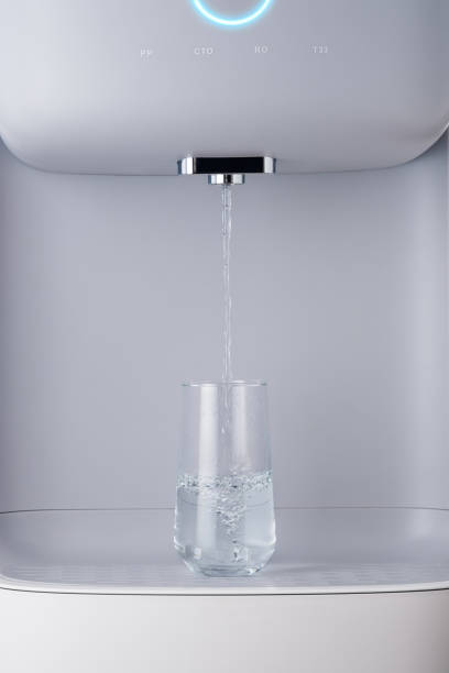 istock Modern technology concept. New water cooler format. A glass of pouring water. Touch panel with glowing indicator. Technological design. 1283630988