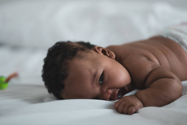 istock Newborn baby girl relaxing on bed 1283632273