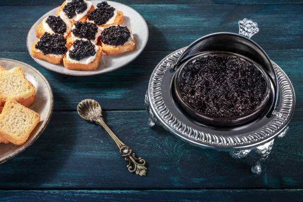 istock Caviar in a vintage bowl with a spoon, with toasts 1283634162