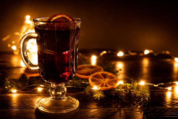istock Mulled wine with cinnamon and an orange and fur-tree branches, a New Year's still-life 1283635781
