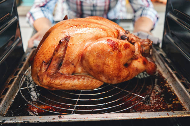 istock Preparing Stuffed Turkey for Holidays in Domestic Kitchen 1283637950