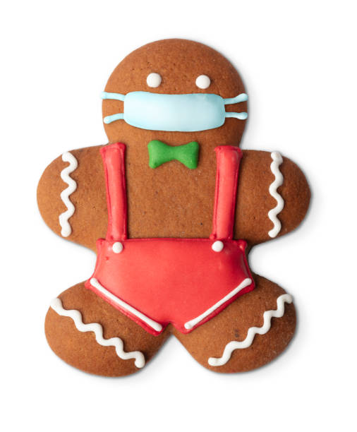 istock Classic gingerbread cookie man with medical mask isolated on white 1283640525