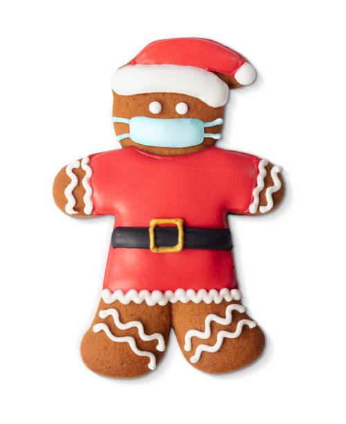 istock Classic gingerbread cookie man with medical mask isolated on white 1283640526