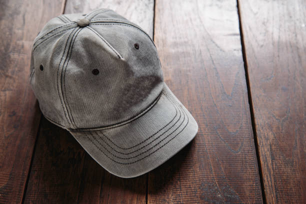 istock cap for man on wooden background 1283665485