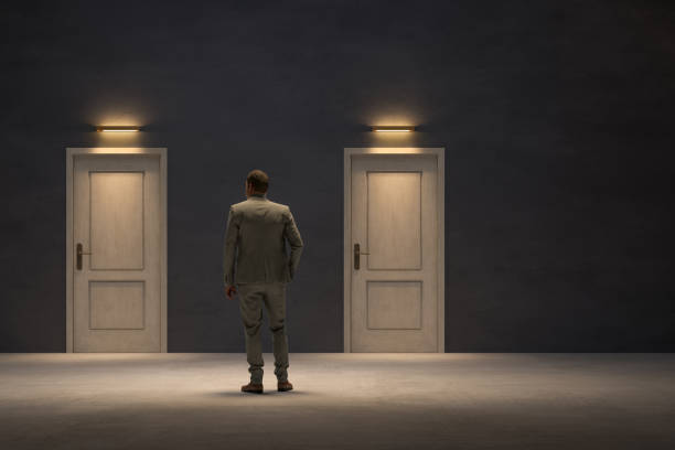 istock Businessman looking for the right door to exit 1283665499