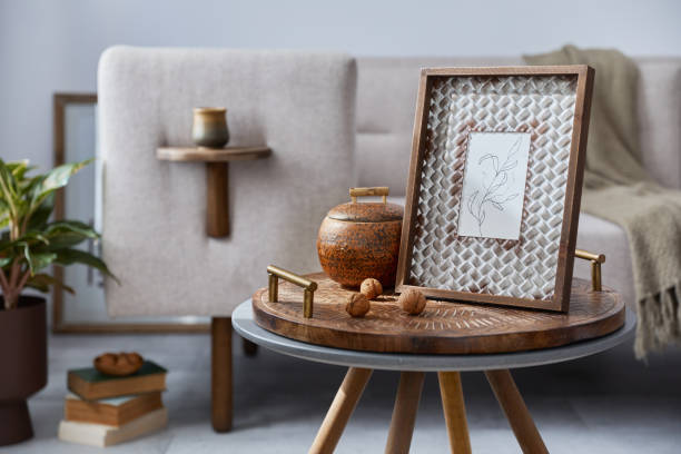 istock Elegant ethnic composition of living room interior with design coffee table, sofa, decoration , mock up frame and acceessories in modern home decor. Template. Details. 1283665515