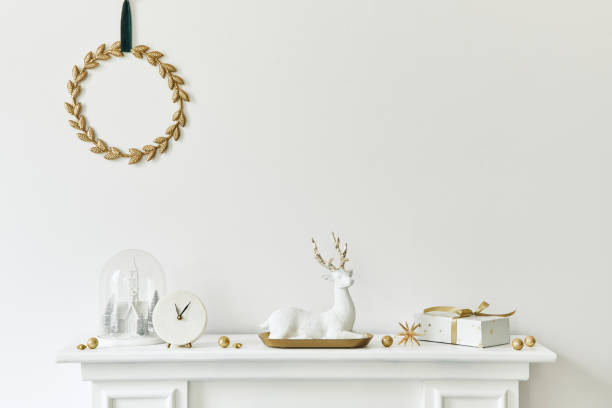 Christmas composition on the white chimney at the living room interior with beautiful decoration. Christmas tree and wreath, candles, stars, light. Copy space. Template.