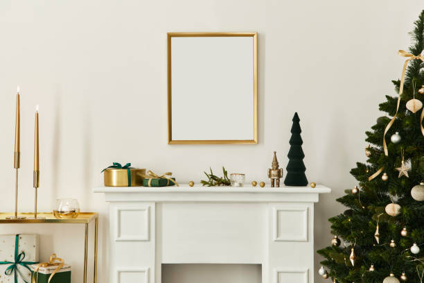 istock Christmas composition with gold mock up poster frame, white chimney and decoration. Christmas trees and wreath, candles, stars, light and elegant accessories. Template. 1283665682