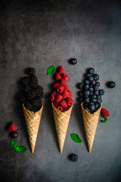 istock Fresh berries in waffle cone on dark stone background 1283667461