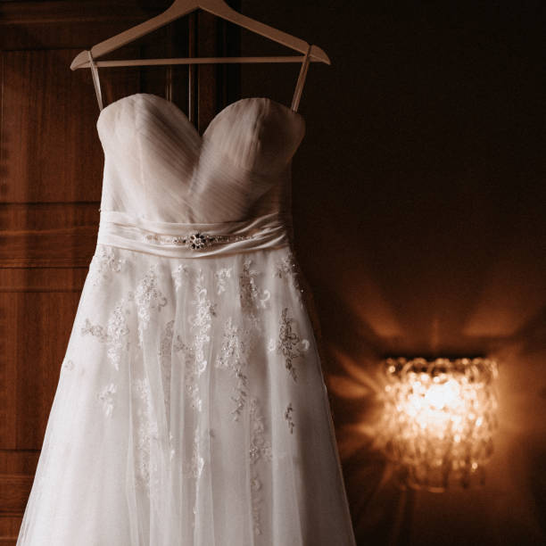 istock Wedding dress hanging on an open window in Instagram look 1283667554