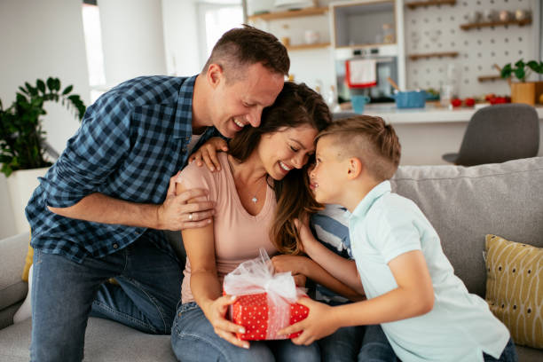 istock Two young sons are giving their mother a gift. 1283668088