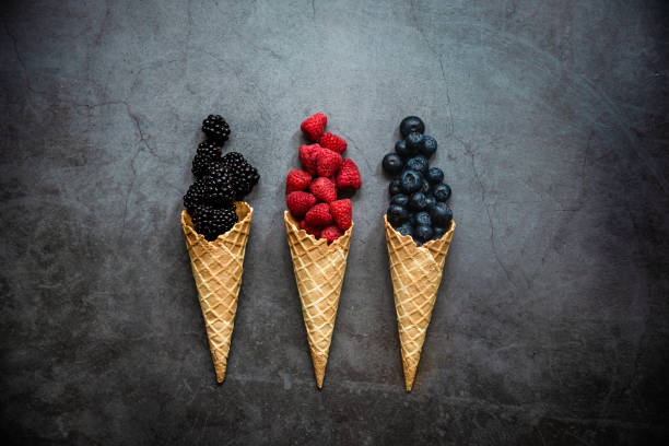 istock Fresh berries in waffle cones on dark stone background 1283669848