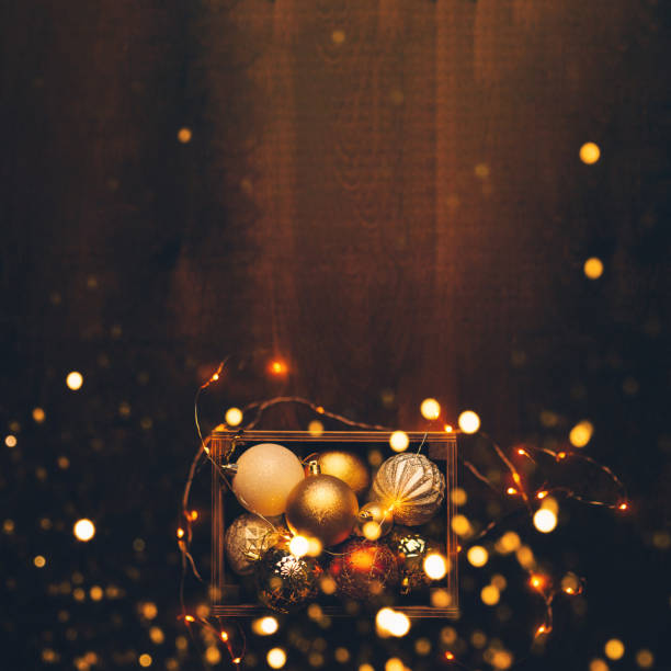 New Year's balls on a wooden background, flat lay. New Year concept with lights