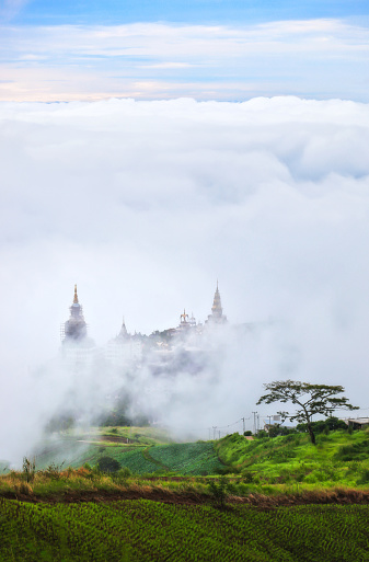 Morning view of the white big buddha in the mist  at Wat Prathat Phasornkaew, Khao Kho, Phetchabun, Thailand
